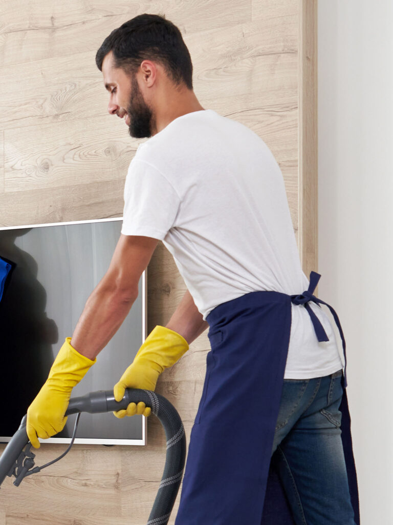 Vacuuming a carpet in an apartment