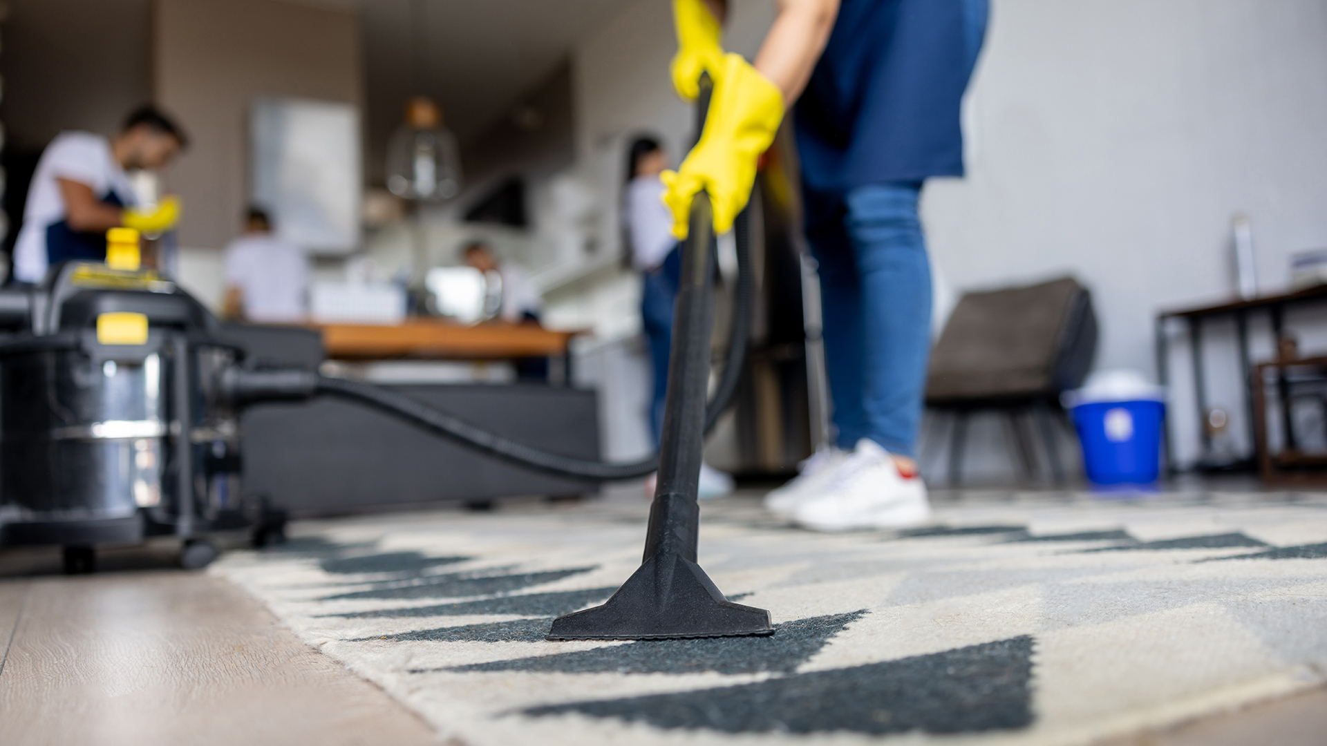 About Us 1 A cleaner vacuuming a carpet in kerala